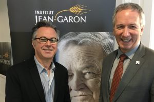 André Lamontagne, ministre de l’Agriculture du Québec, et Yannick Patelli, éditeur de La Vie agricole entourant le portrait de Jean Garon qui trône dans le hall d’entrée de la Maison blanche à Québec.